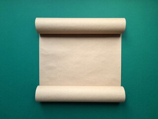 Unfolded blank scroll on green background