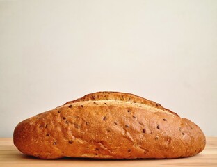 Delicious bread made from wheat flour with flax seeds on a cutting board. Close up
