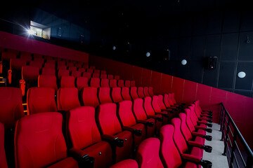 Red cinema empty hall with working projector.