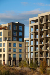 Different stages of construction. Frame of unfinished concrete construction