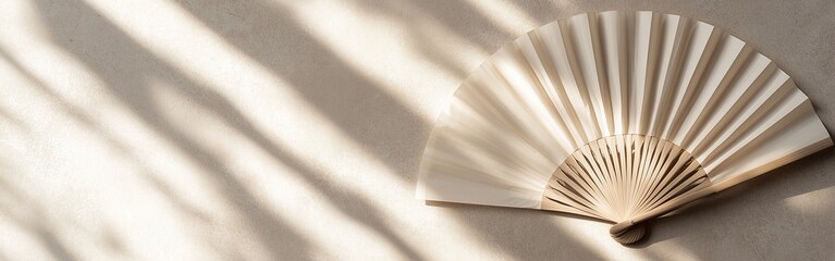Traditional Chinese Paper Fan Resting on a Smooth Stone Surface for a Minimalist Oriental Background, Shadow
