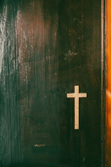 wooden cross on ancient church confession booth