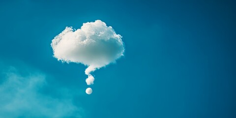 Lone white cloud shaped like a thought bubble in blue sky