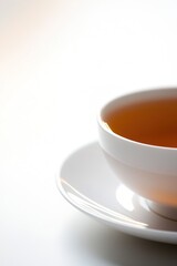Cup of warm tea with reflection on white surface