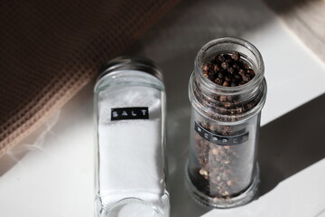 Minimalist Salt Shaker and Pepper Grinder in Natural Light Stock Photo