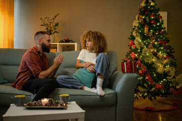 Young couple having relationship problems during christmas holidays