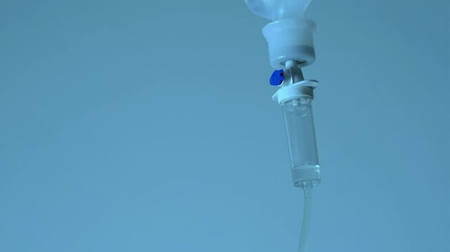 Dripping saline, Dripping medical perfusion close up equipment in clinic background, Medical equipment, Saline Solution IV Drip Fluid for Infusion in Hospital. Intravenous drip in operation room.