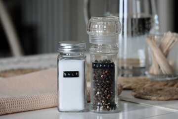 Minimalist Salt Shaker and Pepper Grinder in Natural Light Stock Photo