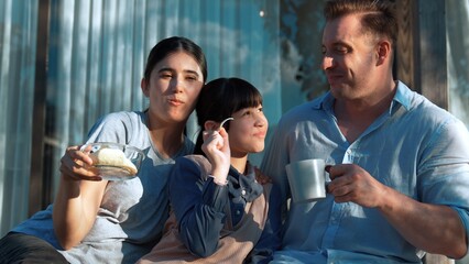 Lovely marriage couple and daughter picnic at outdoor terrace. Family using outdoor activity show love and care to strengthen good growth for child, strong family bond or relationship. Divergence.