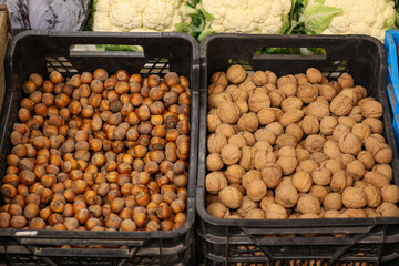 A close-up of walnuts and hazelnuts lying next to each other