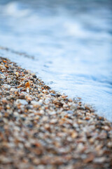 Background of wet stones on a beach surface near water . High quality photo