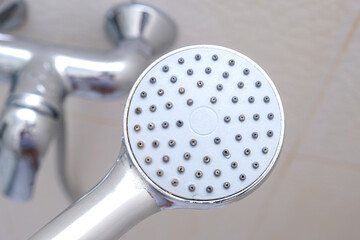 Clean shower head and a water tap on background, everyday routine, self hygiene concept