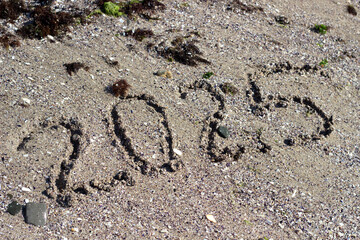 Numbers for 2025 in the sand. New Year 2025.