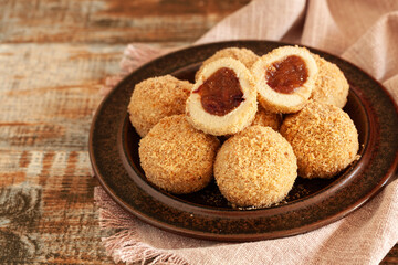 Traditional sweet steamed dumplings with a plum jam, sprinkled with sweet crumble and cinnamon on  plate