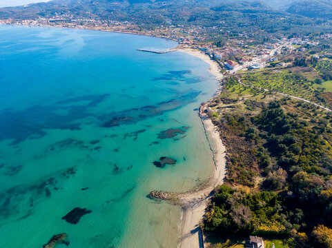 Peaceful aerial wide beach landscape, summer vacation Mediterranean holiday. Waves crash stunning blue ocean bay sea panoramic coastline. Tranquil aerial drone top view. Relaxing sunny beach, seaside
