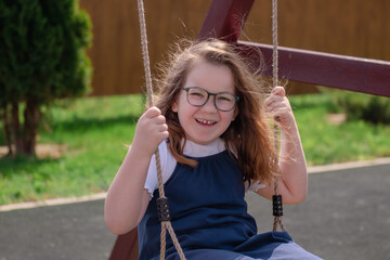 portrait of a happy smiling girl 6 years old playing on a children's playground.looks at the camera close-up