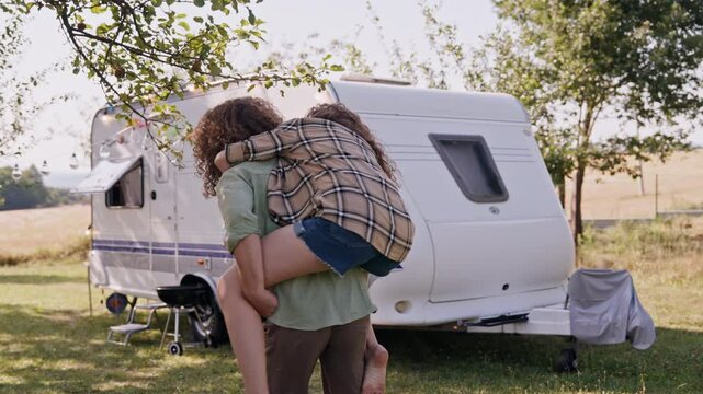 Young couple in love on a roadtrip with caravan, camping and exploring new places.