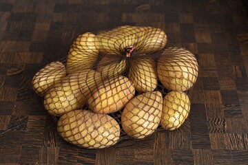 potatoes in a net on a wooden table