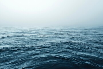 Fototapeta premium Calm Blue Ocean Water with Mist in the Distance