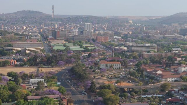 Peak hour traffic in the Jacaranda City, Pretoria, South Africa. Aerial view of busses and cars travelling on main roads