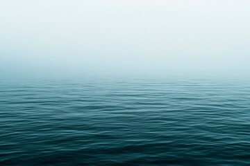 Obraz premium Calm Ocean Water with Foggy Sky