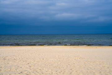 Coastline. White sand, Baltic Sea under  blue sky