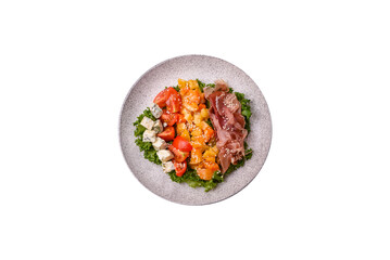 Appetizing salad with prosciutto, pumpkin, cheese and tomatoes