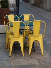 Original green table with four yellow chairs