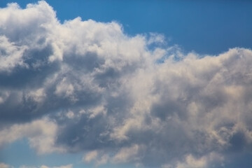 Cumulus cloud line in blue sky close-up