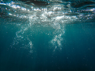 Air bubbles underwater rising to water surface, natural scene, bubbles under water, bubble undersea, sea in crystal clear green water. Real image very suitable for backgrounds, Great for background.