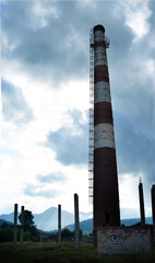 Old abandoned factory with a brick chimney