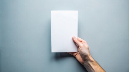 Obraz premium Hand holding blank white flyer brochure booklet in hand 