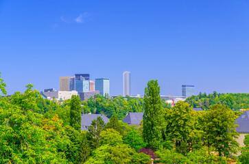 Luxembourg City aerial panoramic view of Kirchberg central business district with skyscraper buildings and Three Acorns Park with green trees, Luxembourg cityscape skyline horizon with blue sky