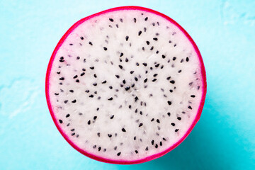 Fresh dragon fruit, pitahaya slice. Blue background. Copy space. Top view.