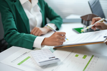 Businesswoman is signing a contract with her real estate agent to purchase a new property