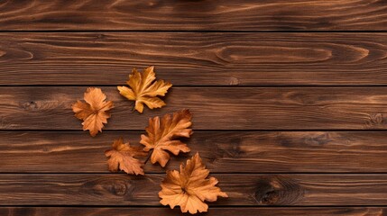 Fototapeta premium Vibrant autumn leaves rest on a wooden table, creating a warm, inviting atmosphere perfect for seasonal projects or celebrations with ample space for text.
