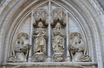 Stone Relief of Saints and Angels on a Gothic Cathedral Archway in Brussels
