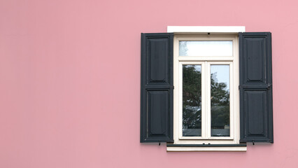 Open wooden shutters on powder pink wall. Rustic background idea concept. Wooden window village cottage house. Copy space, blank, empty.
