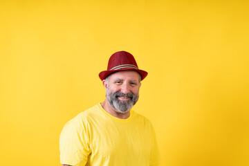 A man wearing a red hat and a yellow shirt