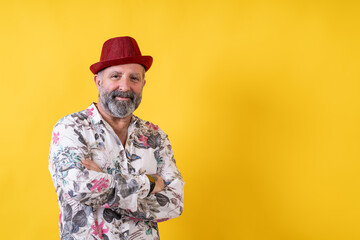 A man wearing a red hat and a white shirt with flowers on it