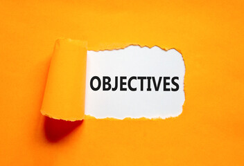 Objectives symbol. Concept word Objectives on beautiful white paper. Beautiful orange paper background. Business objectives concept. Copy space.