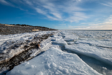 Anticosti Stunning Rocky Coastline with Split Ice on the Seawater Surface in Fractal Patterns Seen From a Low Perspective in the Northern Atlantic Ocean in Winter