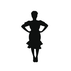 A silhouette of a woman wearing a dress with a ruffled skirt, standing with her hands on her hips 