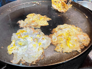 Asian delicious fried seafood with eggs omelet, popular cuisine food in asia.