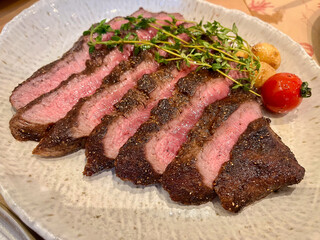 Close up of medium rare A5 steak on plate.