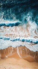 Obraz premium Aerial view of a serene beach with gentle waves crashing on golden sand under bright sunlight