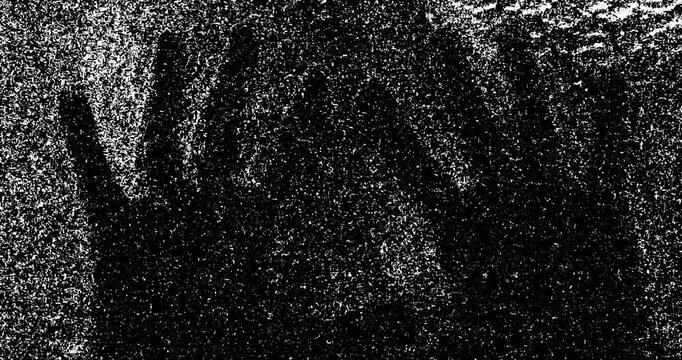 Silhouette of a men's hands touching glass and static tv noise, scary movie tv screen noise