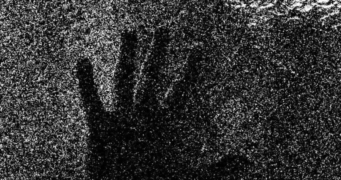 Silhouette of a men's hands touching glass and static tv noise, scary movie tv screen noise