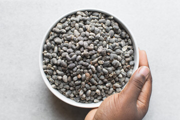 overhead view of blue speckled beans in a white bowl, top view of nigerian army beans, speckled heirloom beans in a ceramic bowl