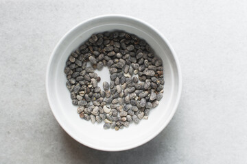 overhead view of blue speckled beans in a white bowl, top view of nigerian army beans, speckled heirloom beans in a ceramic bowl